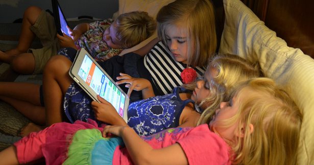 Kids with ipad in bed